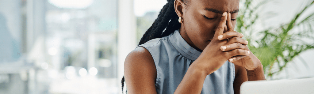 Stressed black businesswoman working on a laptop in an office