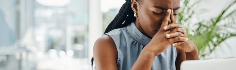 Stressed black businesswoman working on a laptop in an office