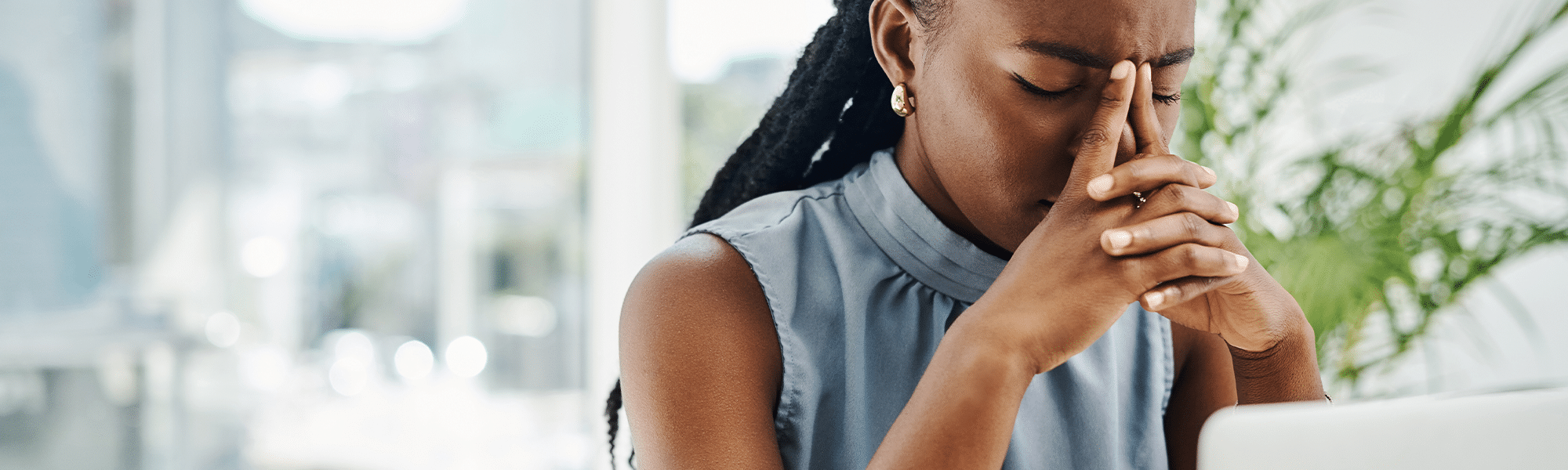 Stressed black businesswoman working on a laptop in an office