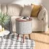 Scene Graph for Drum Shape Speaker (4) (1) Sonic Side Table with a built-in speaker next to a sofa in a living room.