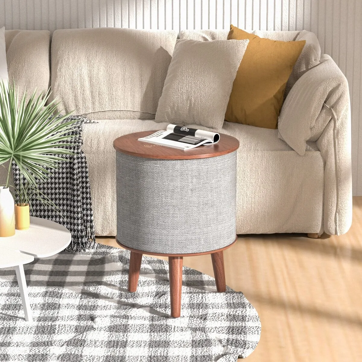 Scene Graph for Drum Shape Speaker (4) (1) Sonic Side Table with a built-in speaker next to a sofa in a living room.