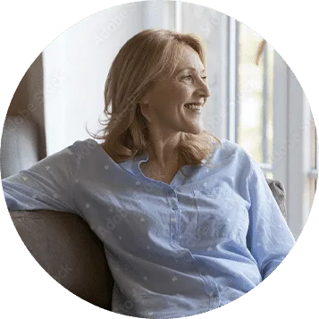 Woman relaxing in an armchair beside a window