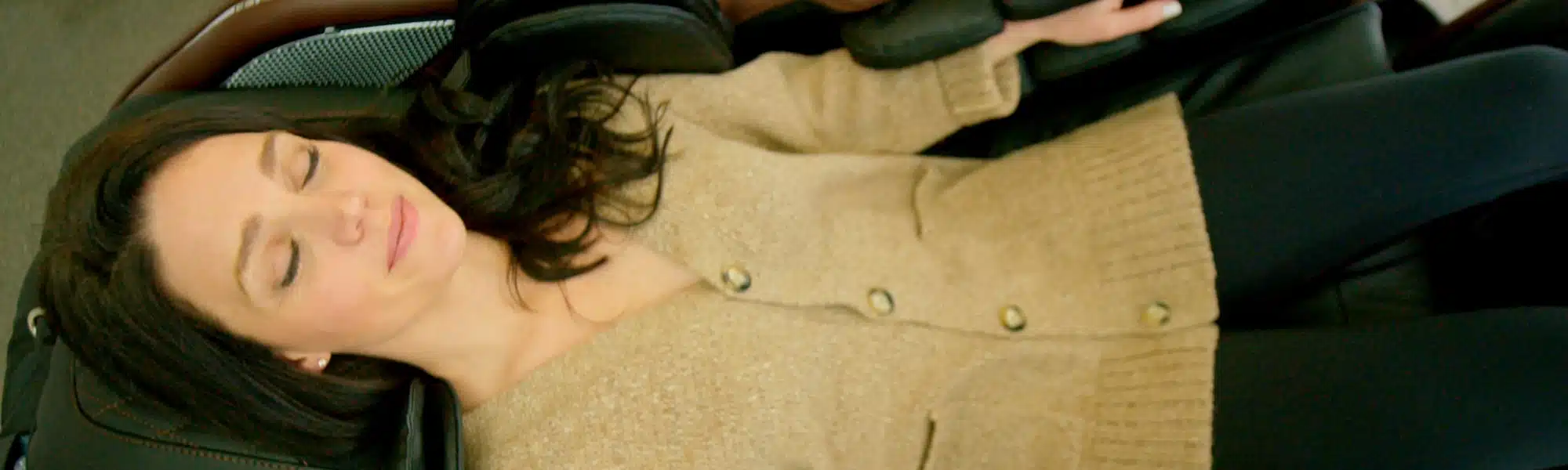Woman resting her head back with her eyes closed